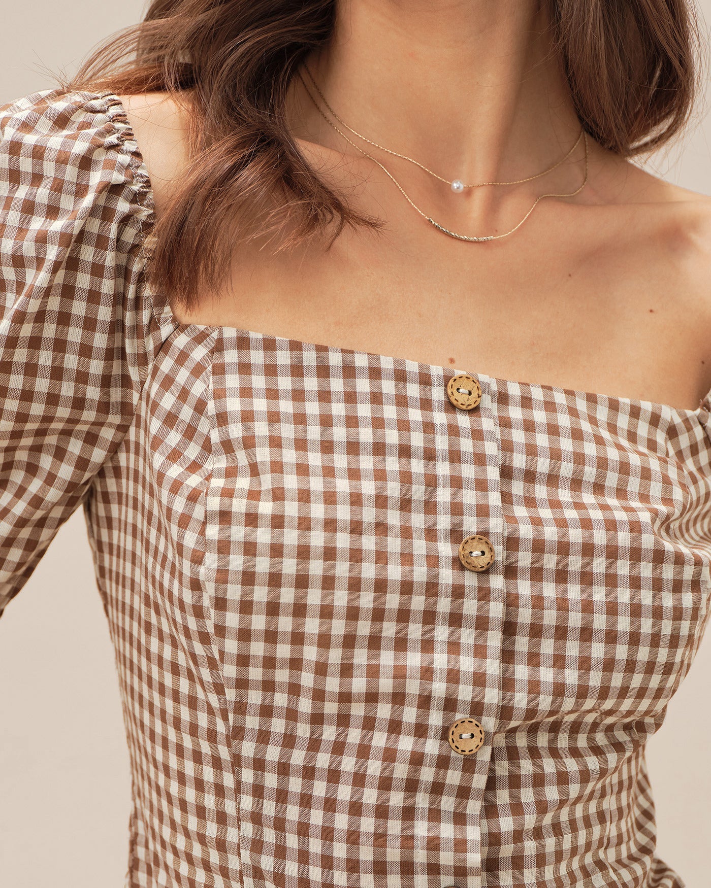 Blusa a cuadros marrón con cuello cuadrado y mangas abullonadas